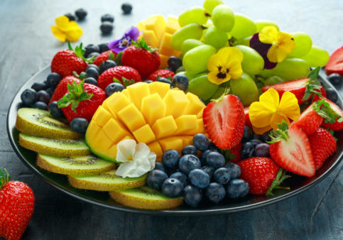 Colorful Mixed Fruit platter with Mango, Strawberry, Blueberry, Kiwi and Green Grape. Healthy food.